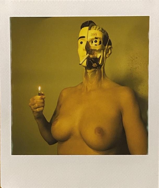 A woman with a partially exposed mechanical face holds a lit lighter.