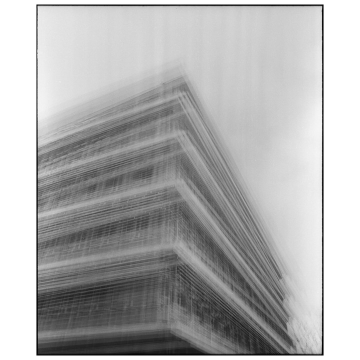 A blurry, streaky image of a building with many horizontal lines.
