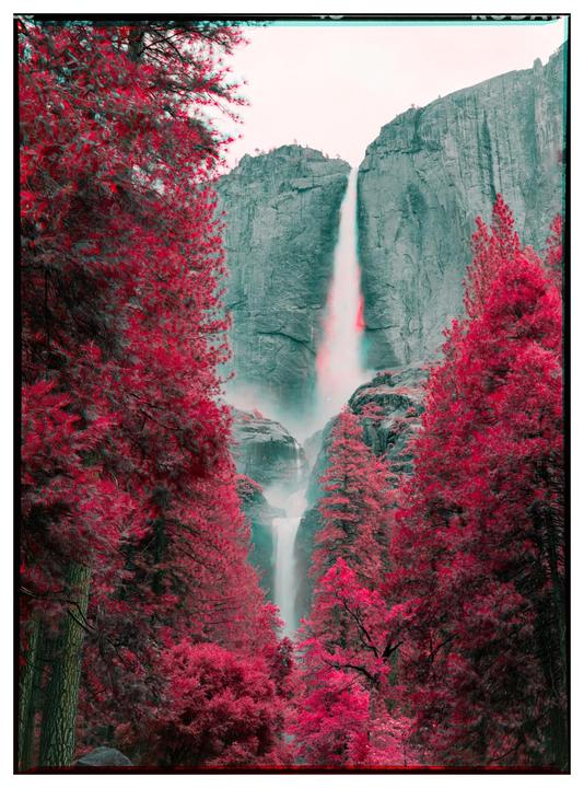 A waterfall cascades down a rocky cliff, surrounded by trees with vibrant red foliage.