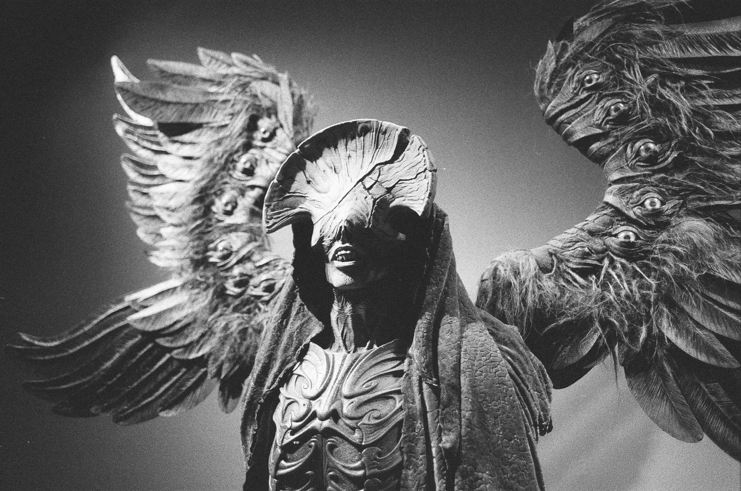 A statue of the Angel of Death from Guillermo del Toro: At Home with Monsters is shown with large wings and a textured body.