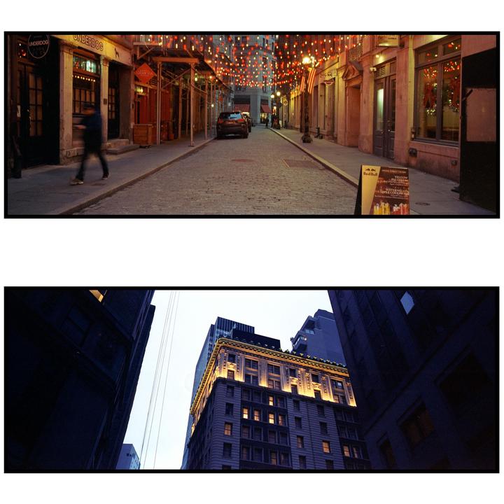 A person walks down a cobblestone street lined with buildings and string lights, while a second image shows a low-angle view of a tall building with illuminated windows.