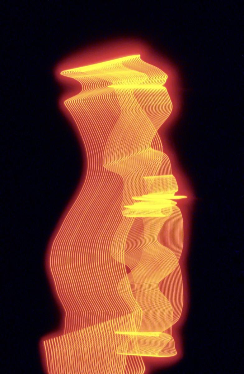 Orange and yellow light trails form abstract shapes against a dark background.