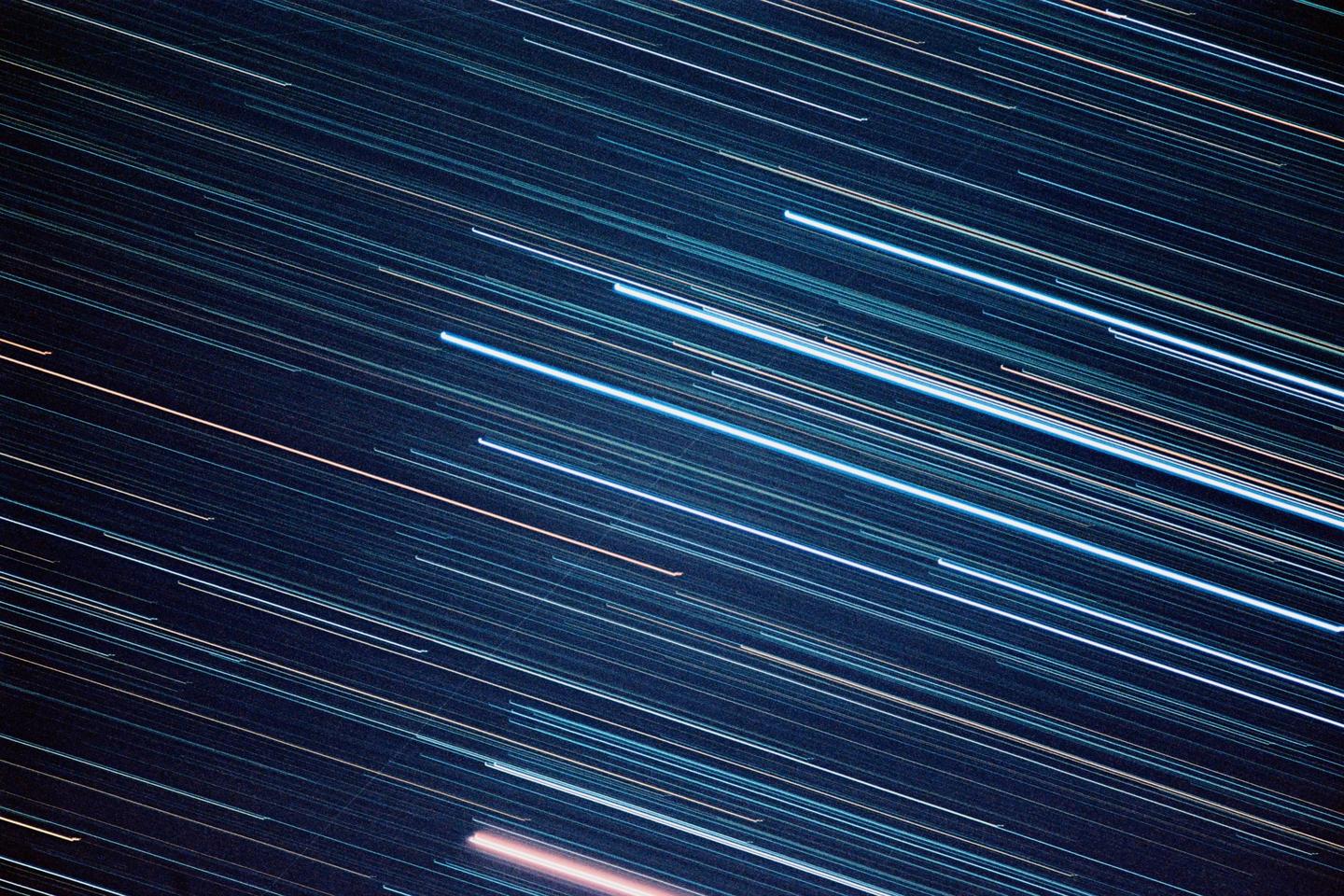 Streaks of light from stars are visible against a dark night sky.