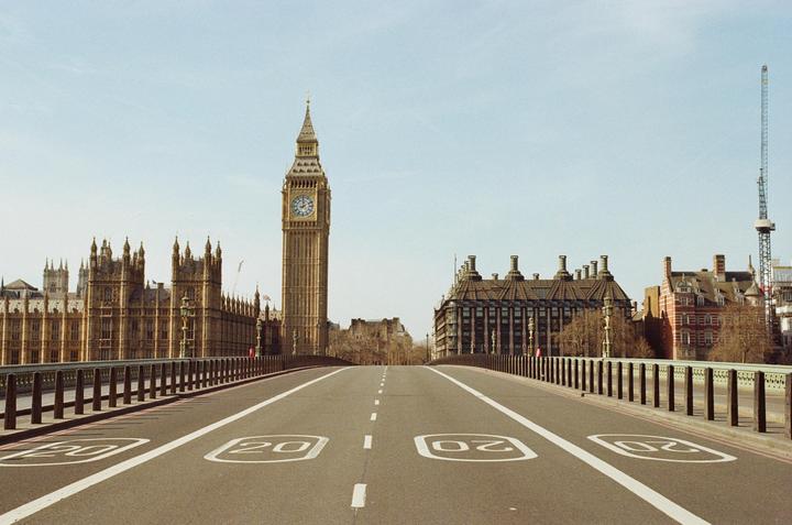 A wide shot of an empty Westminster Bridge with Big Ben and the Houses of Parliament in the background.