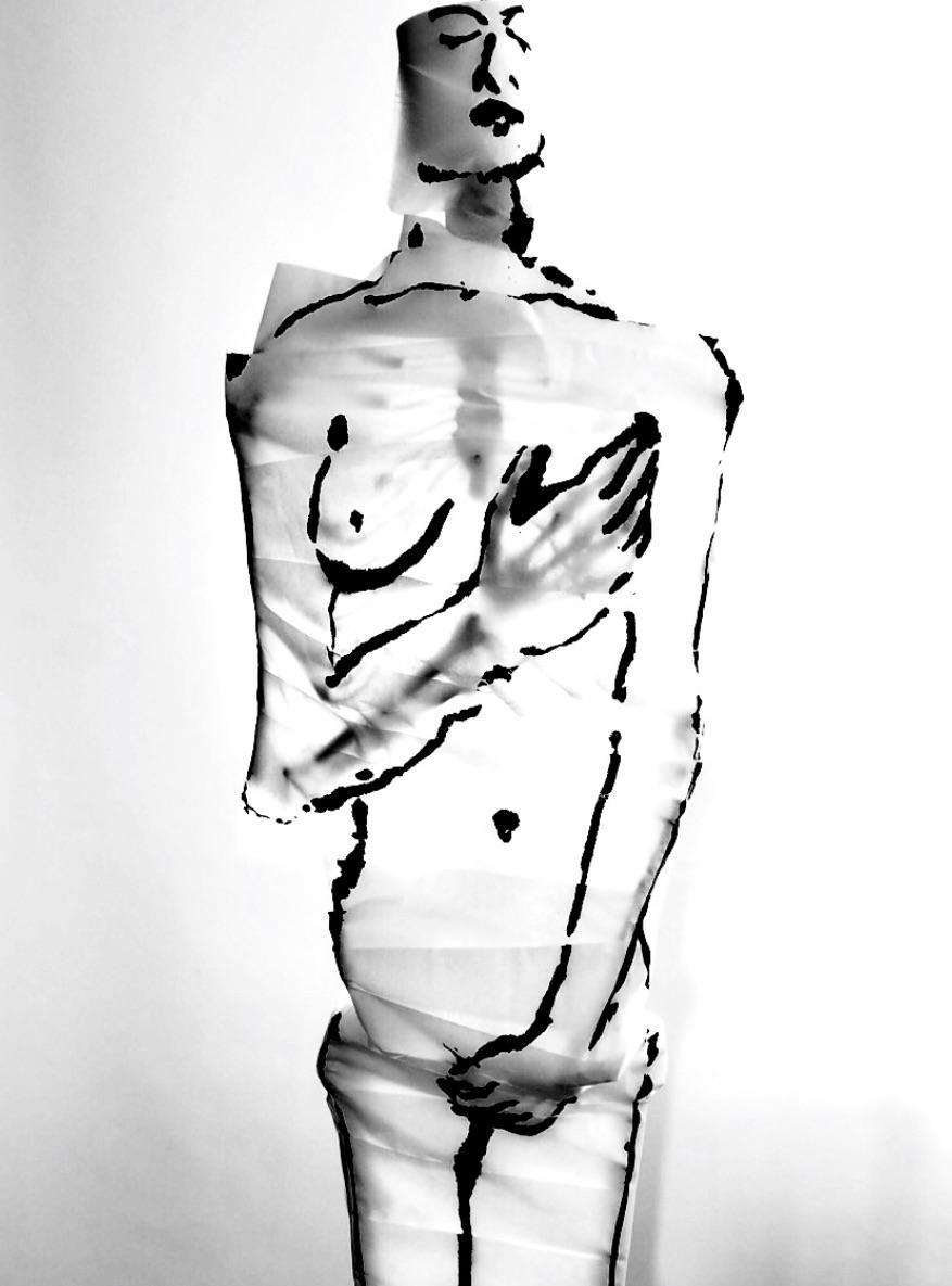 A skeleton wrapped in toilet paper with ink drawings is backlit against a white background.