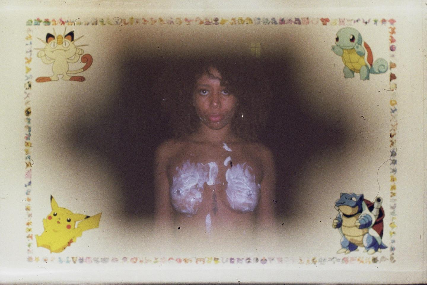 A woman with cream on her chest is centered in a frame decorated with pokemon characters.