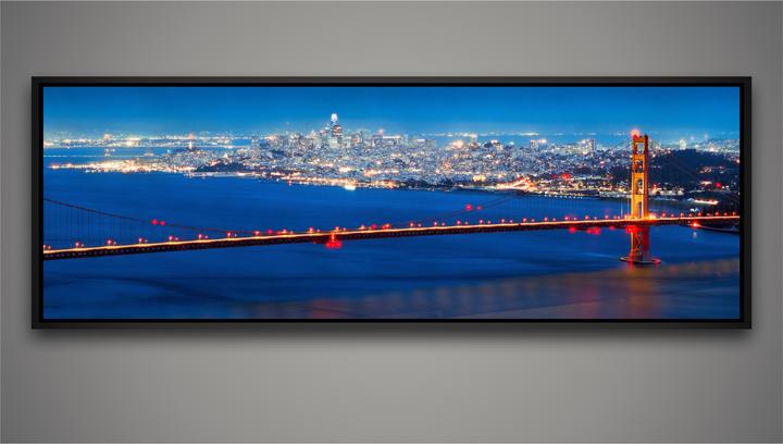 The Golden Gate Bridge is illuminated at night with the San Francisco skyline in the background.