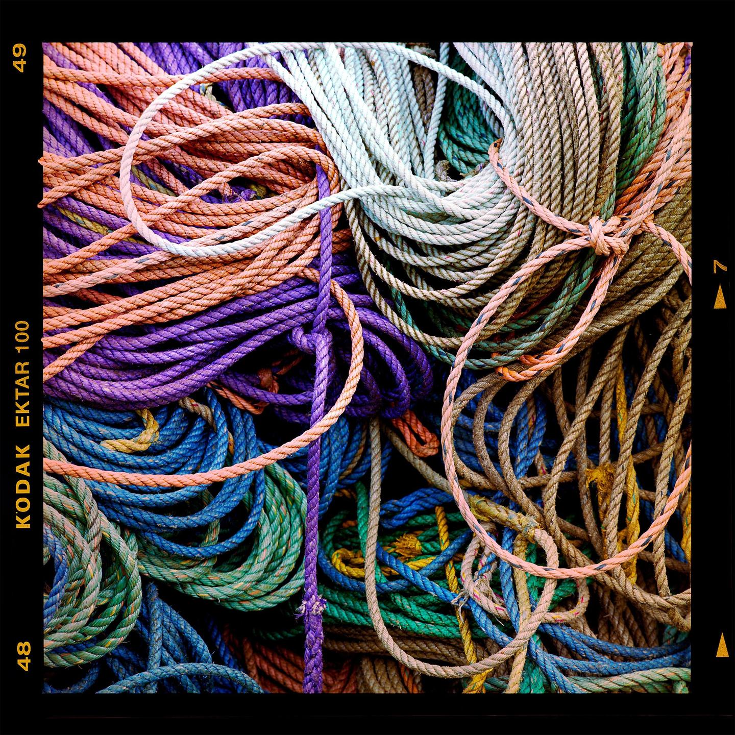 A large pile of colorful rope fills the frame.