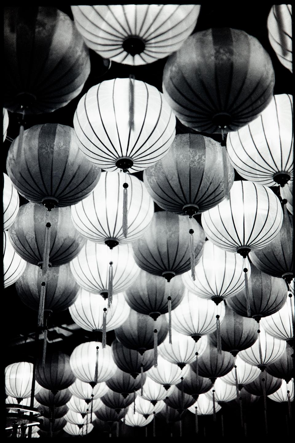Many round lanterns hang from above, some with tassels.