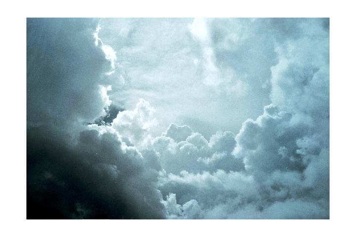A dramatic sky is filled with bright and dark clouds.