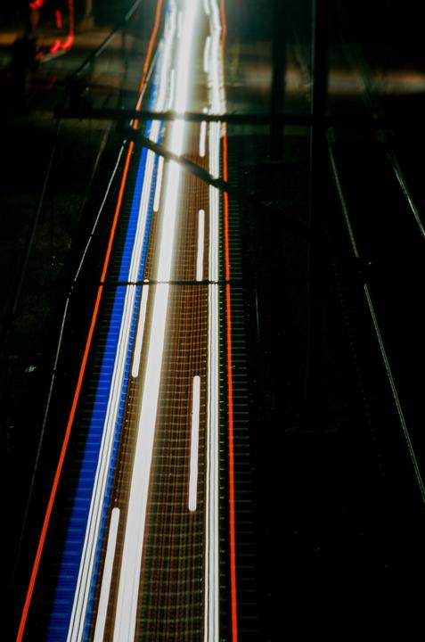 Light trails from vehicles on a road at night are captured with a long exposure.