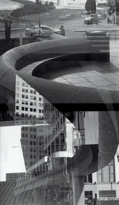 A double exposure shows a street with cars and a person, a curved concrete structure, and multiple buildings.