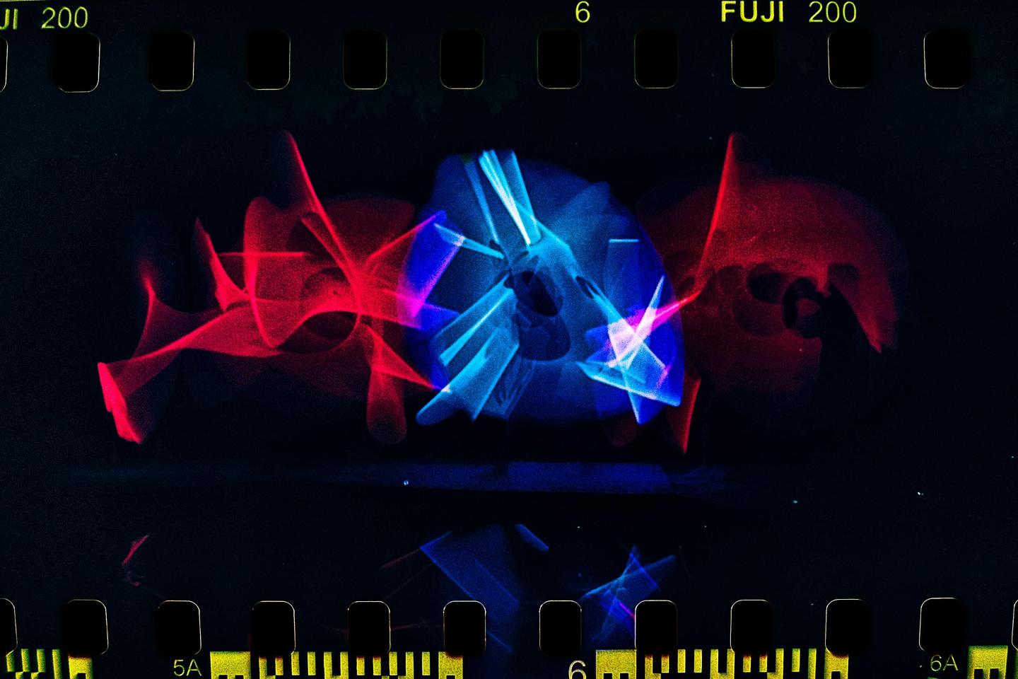 Red and blue light trails are visible against a dark background.