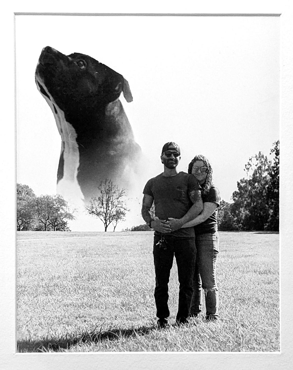 A couple stands in a grassy field with a large dog head superimposed in the background.