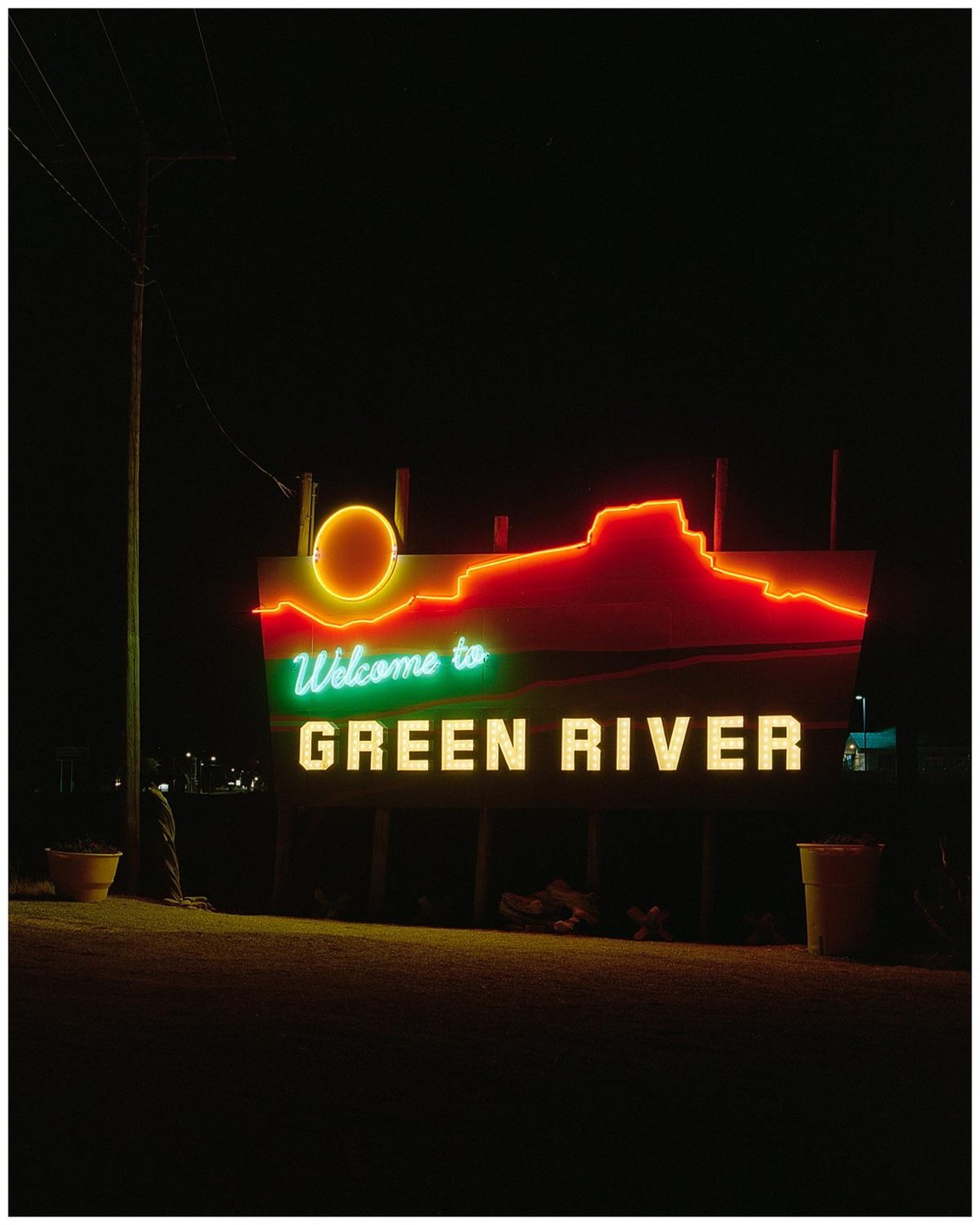 A neon sign welcomes visitors to Green River at night.