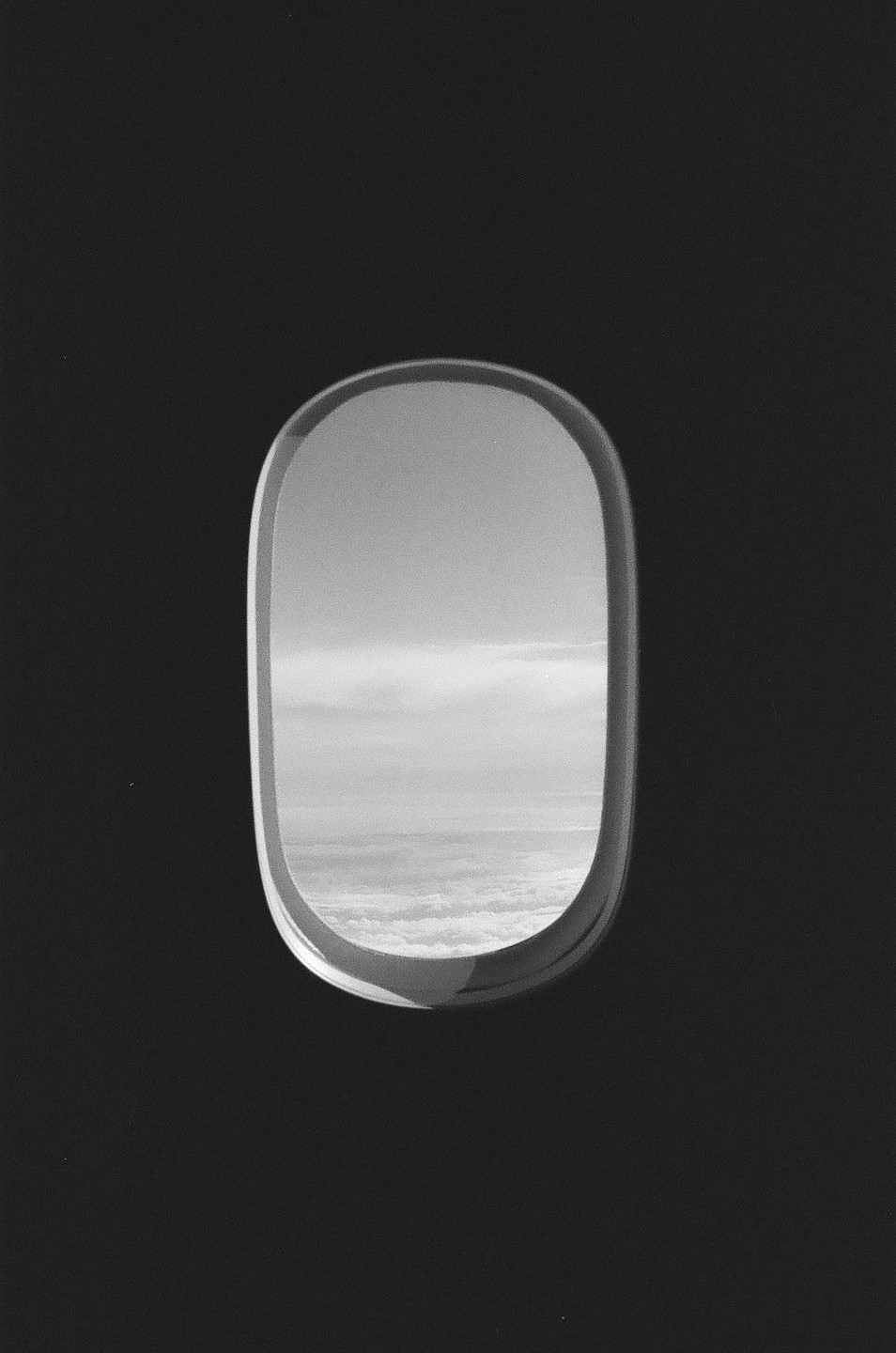 Clouds are visible through an airplane window.