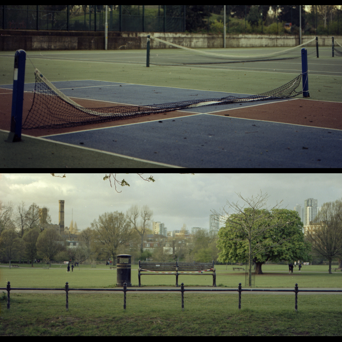 A tennis court with a fallen net is shown above a park with a bench and a distant city.