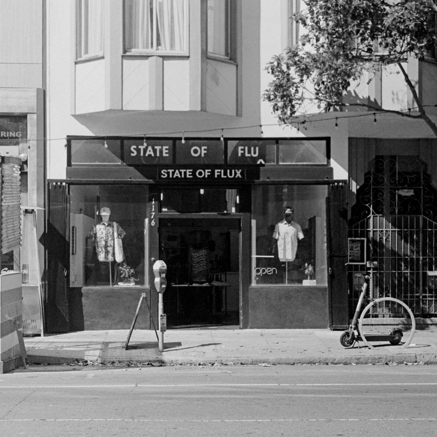 A storefront with the name "State of Flux" is visible from across the street.