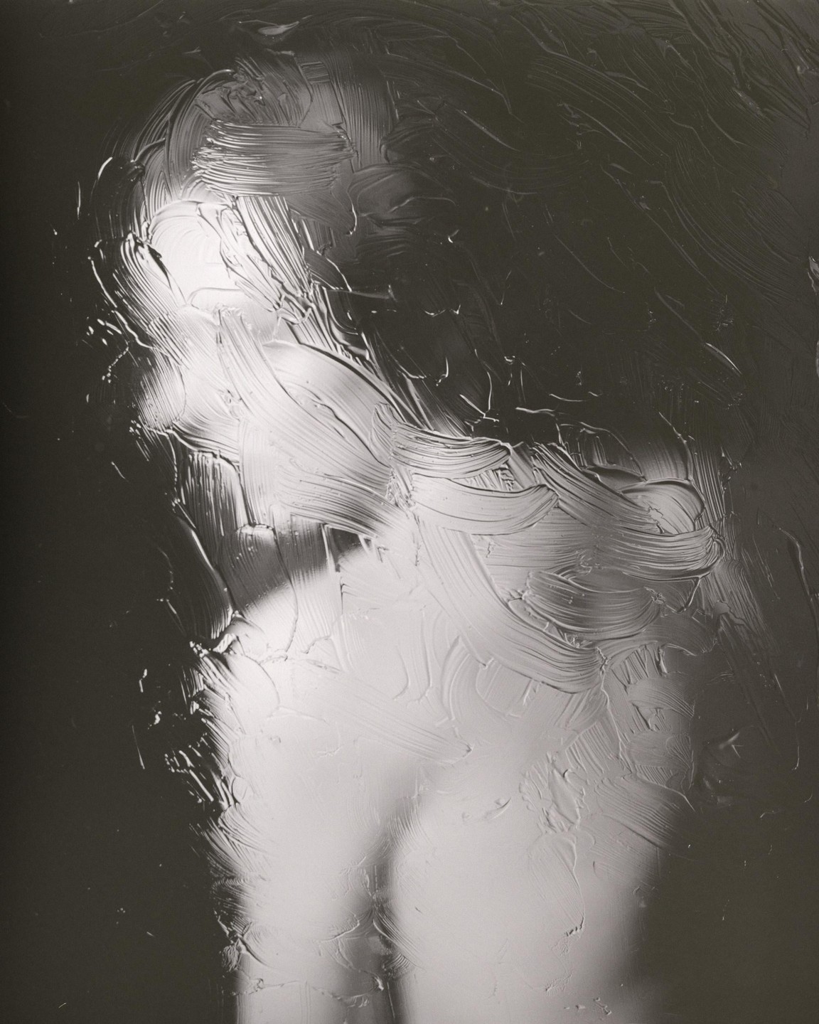 A woman's profile is visible through a textured, translucent surface.