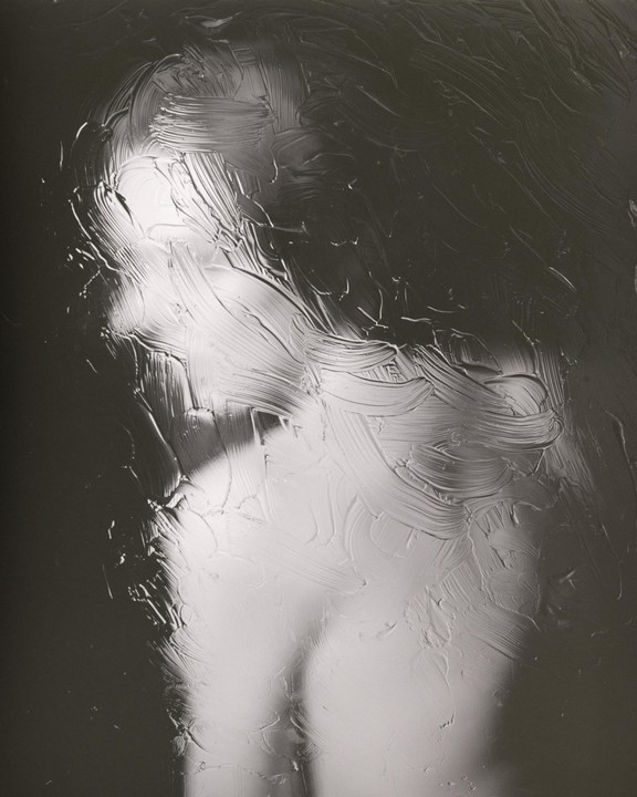 A woman's profile is visible through a textured, translucent surface.