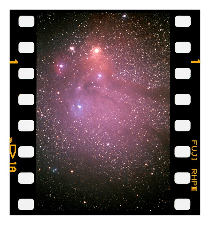A long exposure photograph captures the Rho Ophiuchi cloud complex, revealing a vibrant nebula and numerous stars.