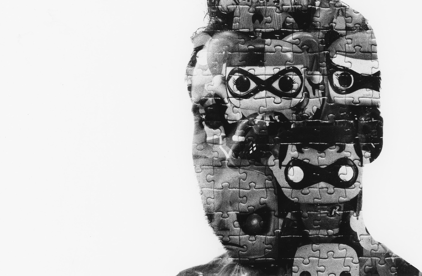 A black and white double exposure shows a man's profile overlaid with a jigsaw puzzle featuring cartoon characters.