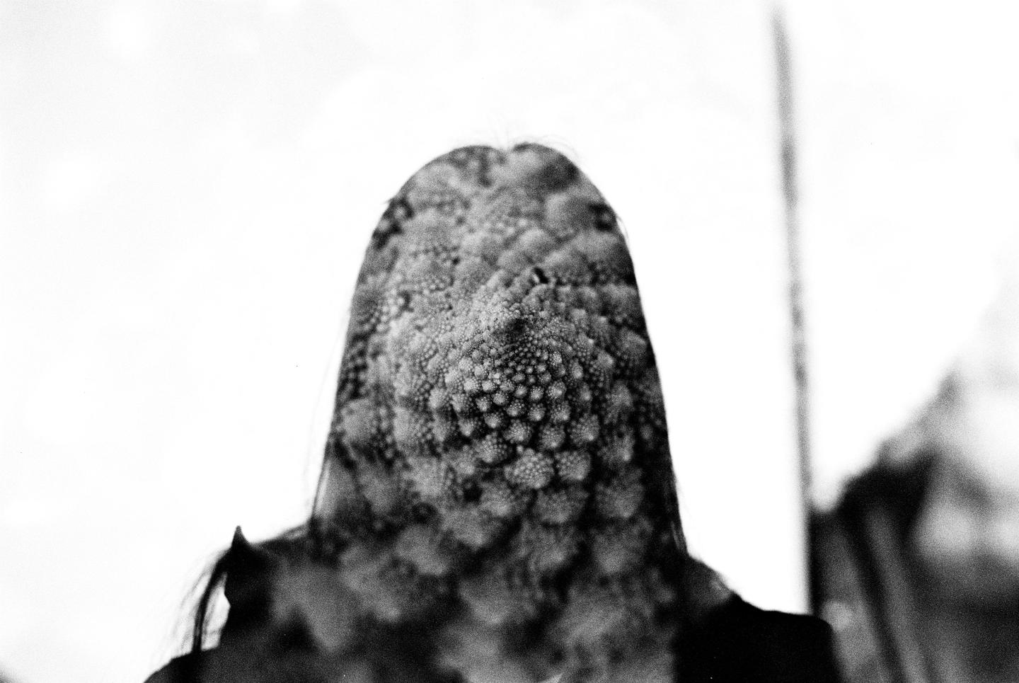 A woman's head is superimposed with a Romanesco broccoli in a double exposure.