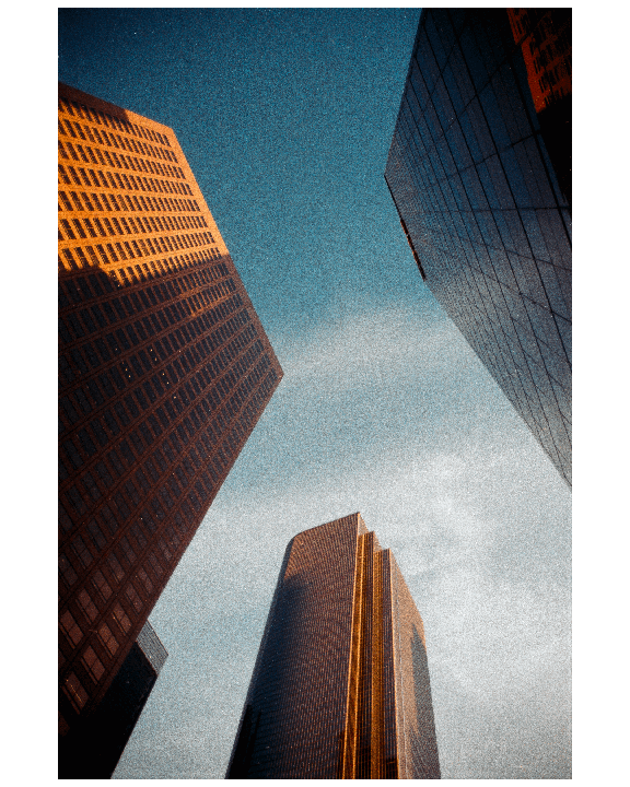 Three skyscrapers with reflective windows are visible from a low angle against a blue sky.