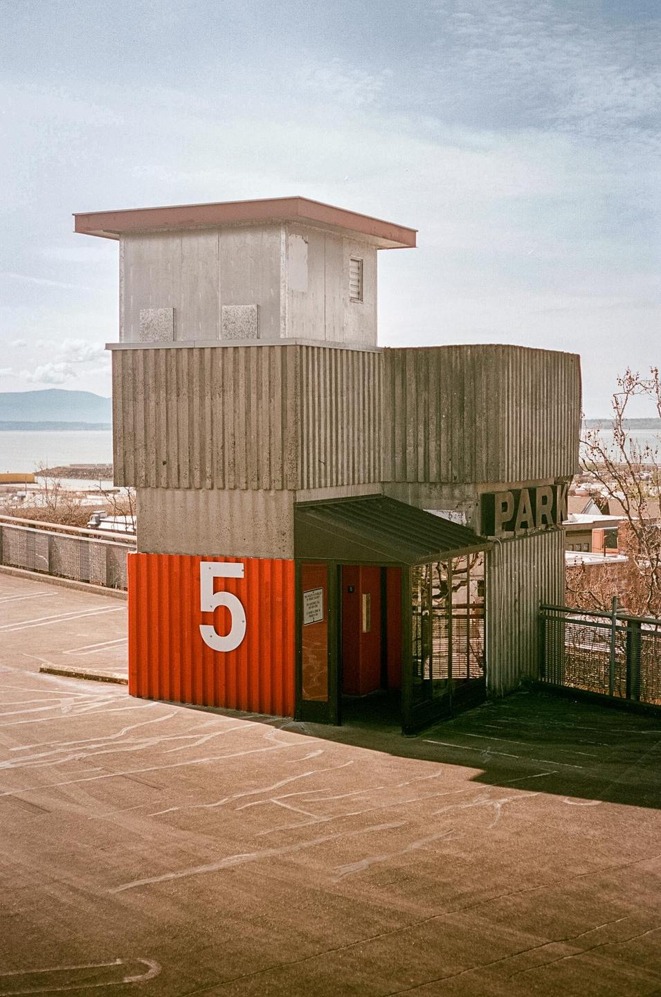 A concrete parking structure with an orange base and a white number 5 is visible from an elevated perspective.