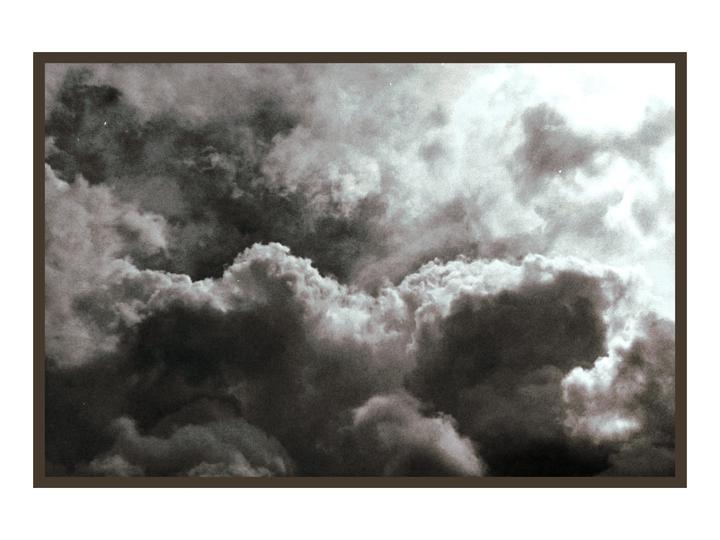 A dramatic sky is filled with dark, heavy clouds and bright highlights.
