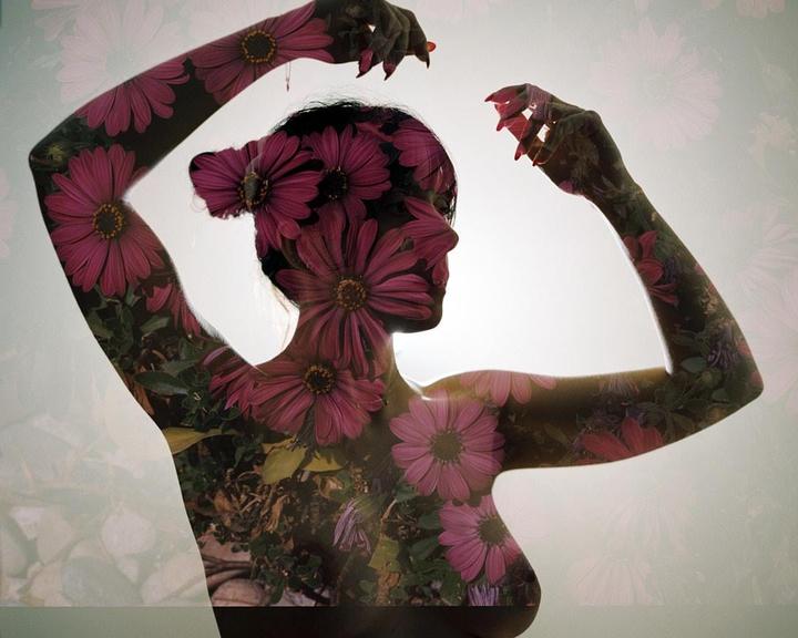 A woman's silhouette is filled with an image of pink flowers and green foliage.