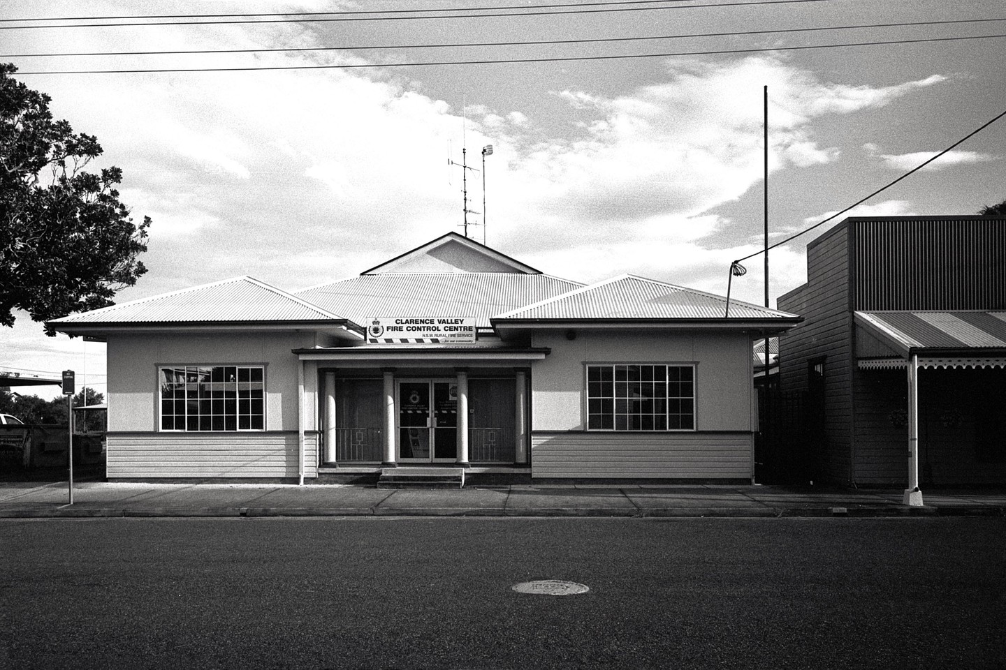 A building with a sign that reads "Clarence Valley Fire Control Centre" stands next to a street.