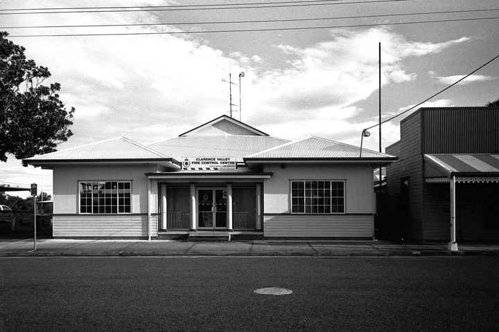 A building with a sign that reads "Clarence Valley Fire Control Centre" stands next to a street.
