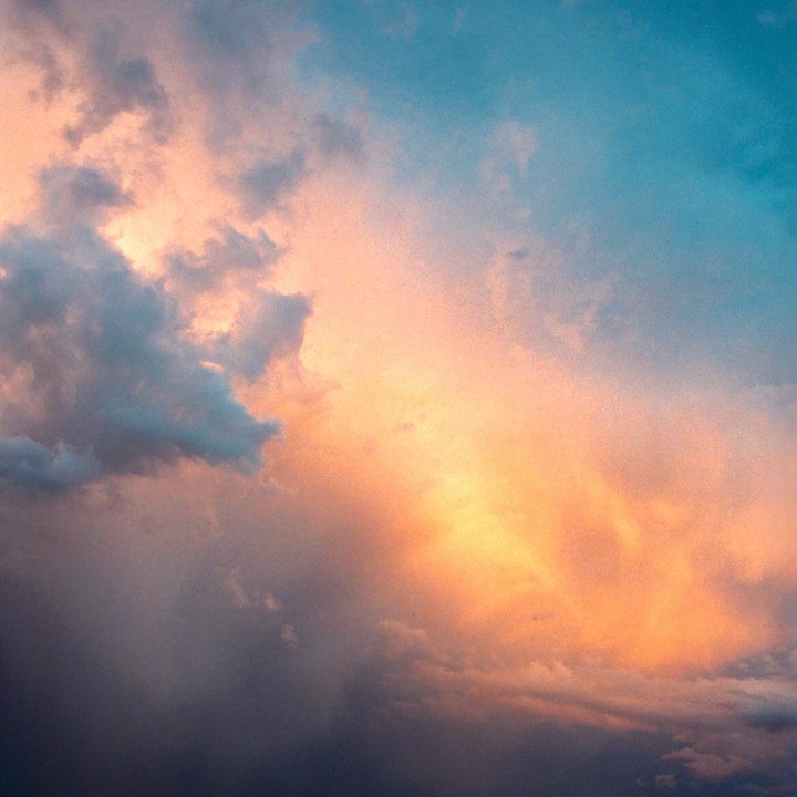 The sky is filled with clouds in shades of orange, blue, and gray.