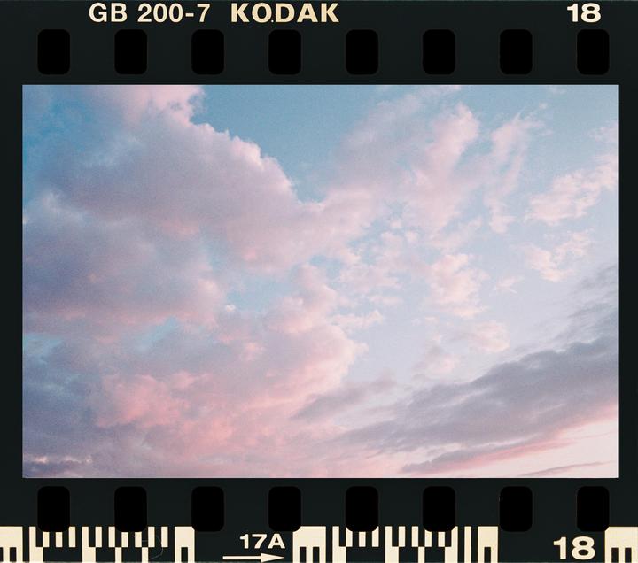 The sky is filled with pink and white clouds during sunset.