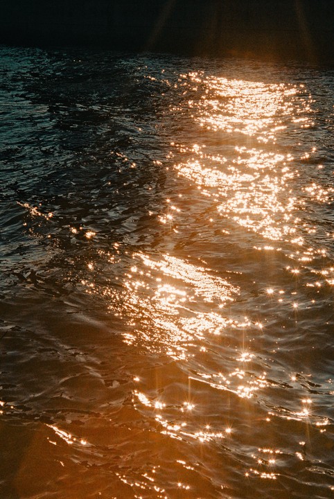 Sunlight reflects off the surface of rippling water.