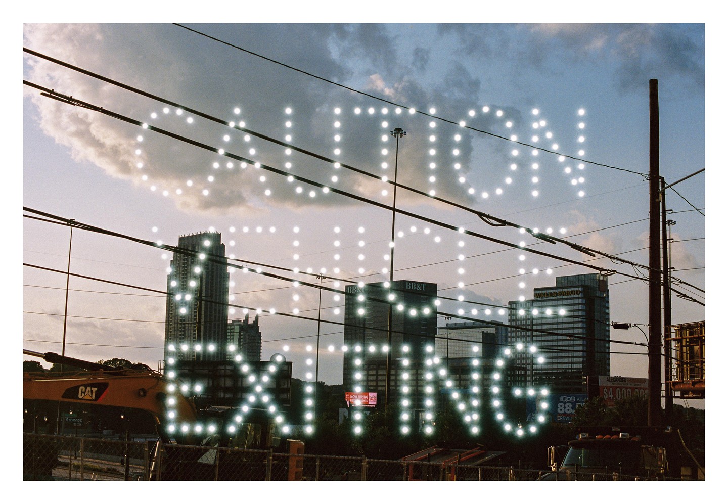 A double exposure shows the words "CAUTION" and "EXITING" in bright lights over a city skyline with power lines and construction equipment.