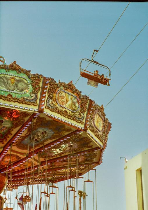 A carousel and a ski lift are visible against a clear sky.
