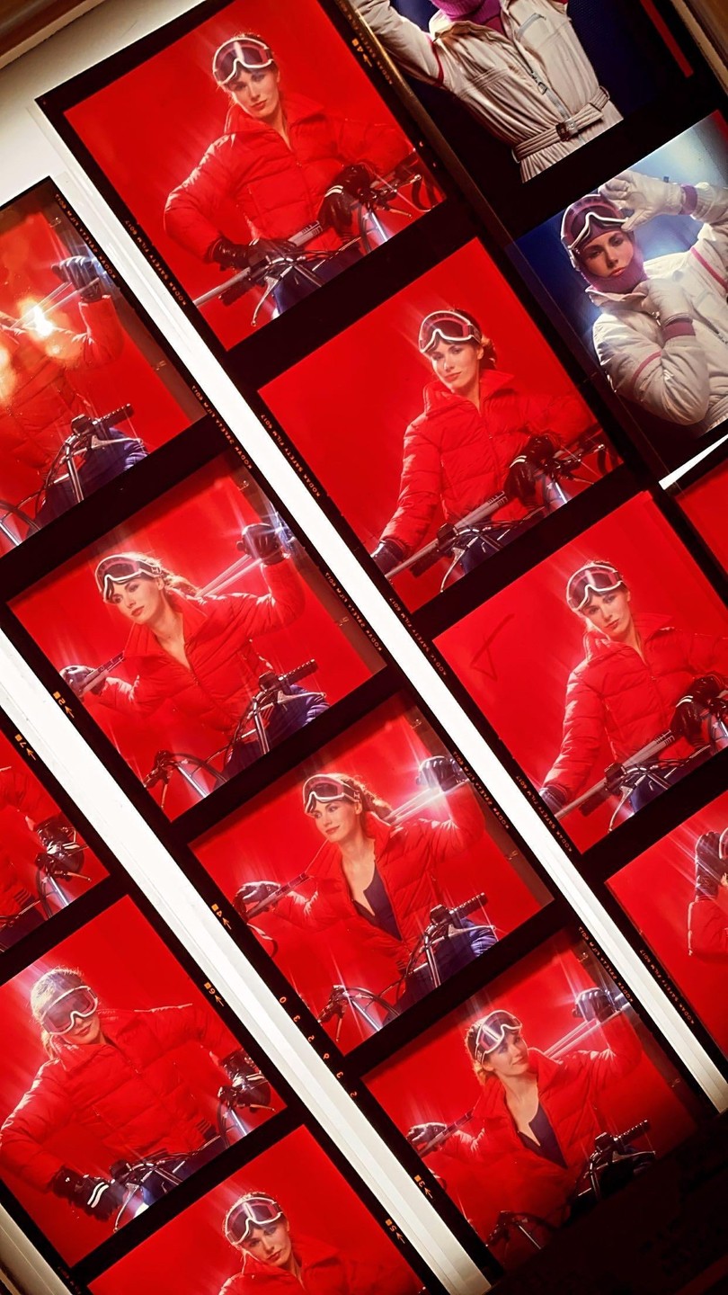 A contact sheet displays multiple images of a woman in ski gear posing with a snowmobile.