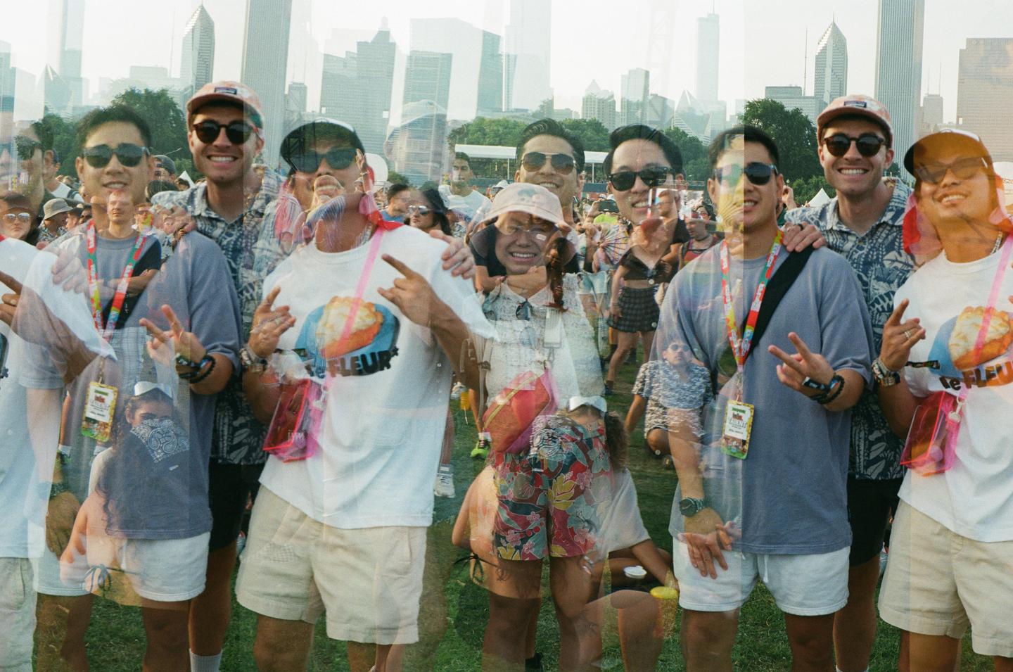 A group of men and women are double exposed in a crowd with a city skyline in the background.
