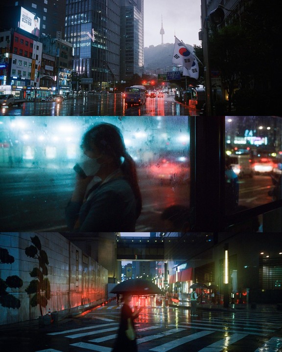 A collage of three street scenes in Seoul at night, with a woman in a mask looking out a window, a street with cars and a flag, and a person with an umbrella crossing a street.