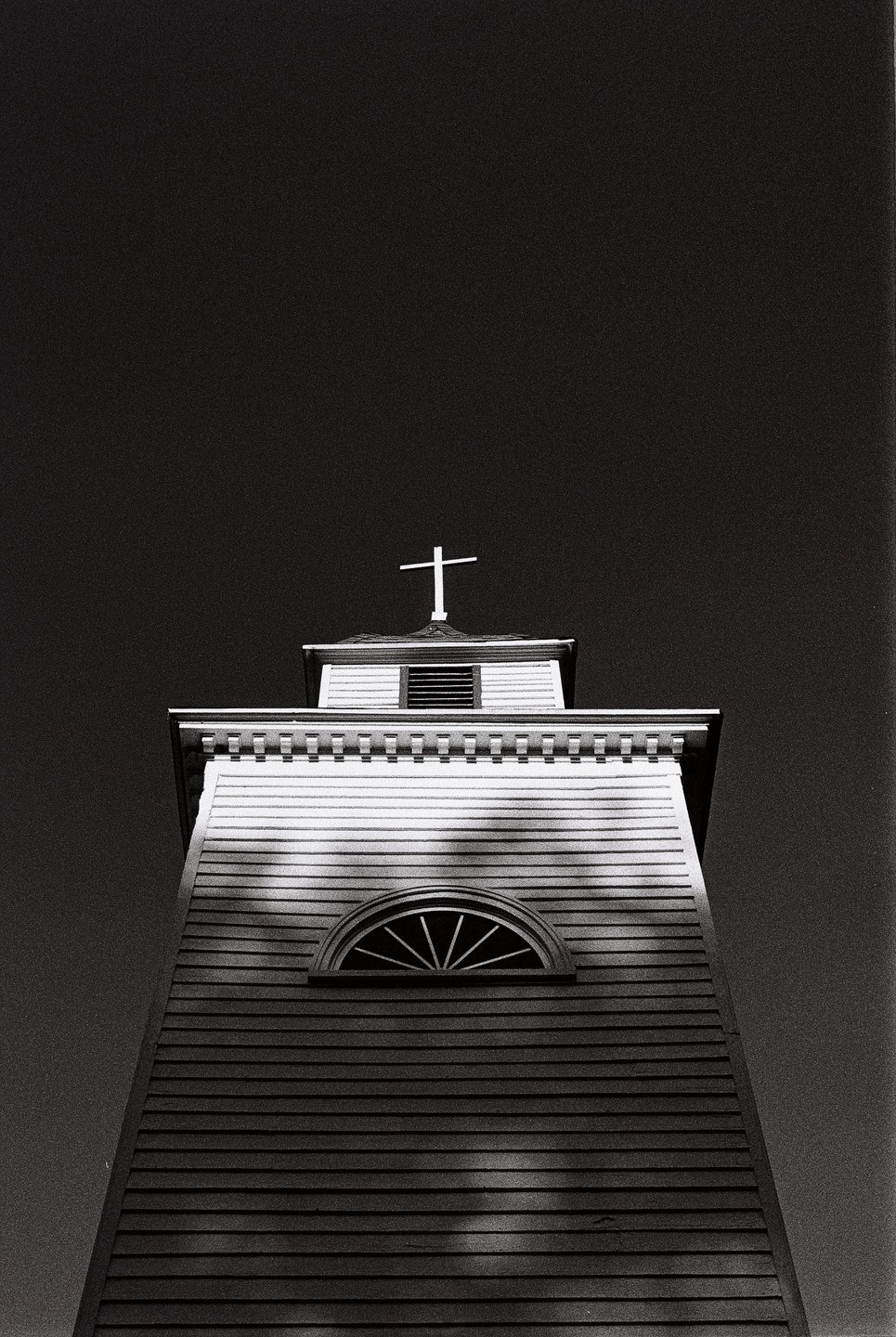 A low-angle view shows the steeple of St. Paul's Episcopal Church against a dark sky.