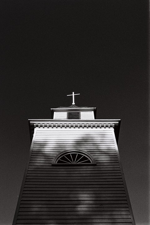 A low-angle view shows the steeple of St. Paul's Episcopal Church against a dark sky.