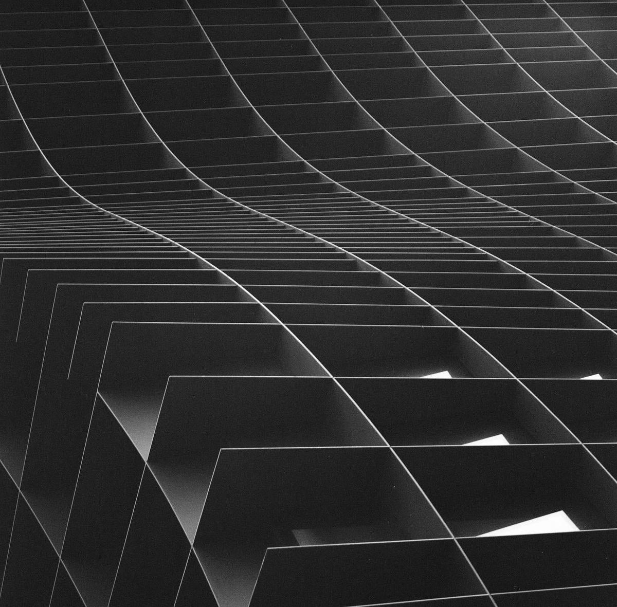 A black and white abstract image shows a grid of lines and shapes that resemble a waffle.