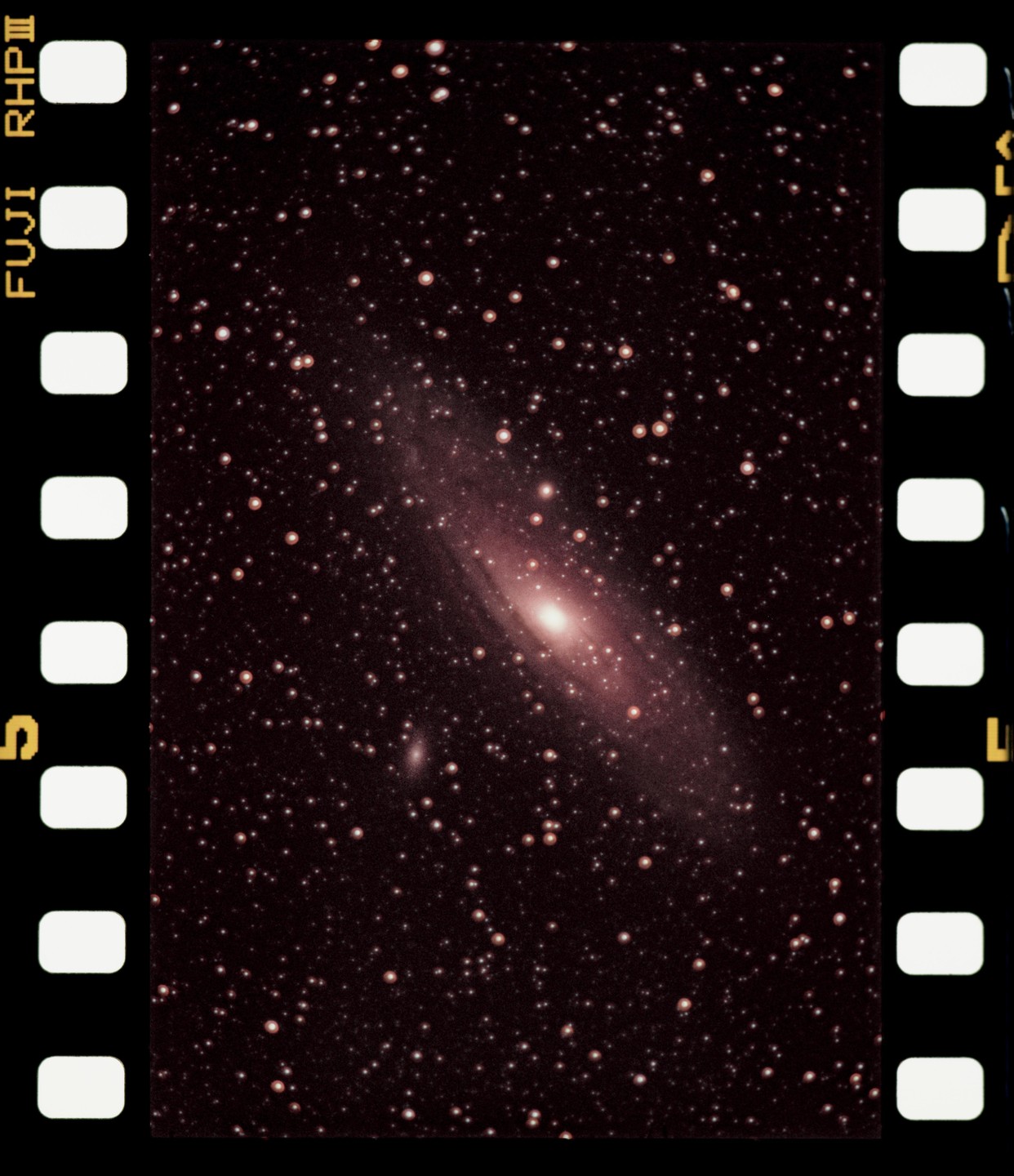 A galaxy is visible in the night sky, surrounded by many stars.