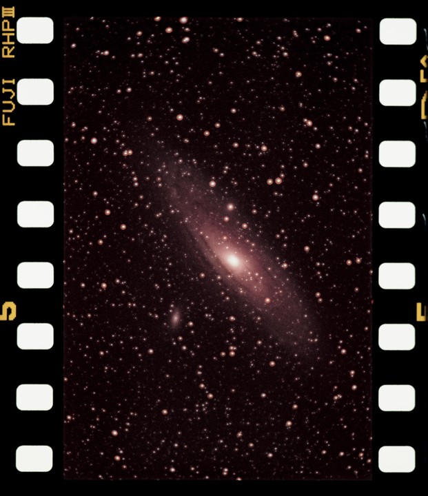 A galaxy is visible in the night sky, surrounded by many stars.