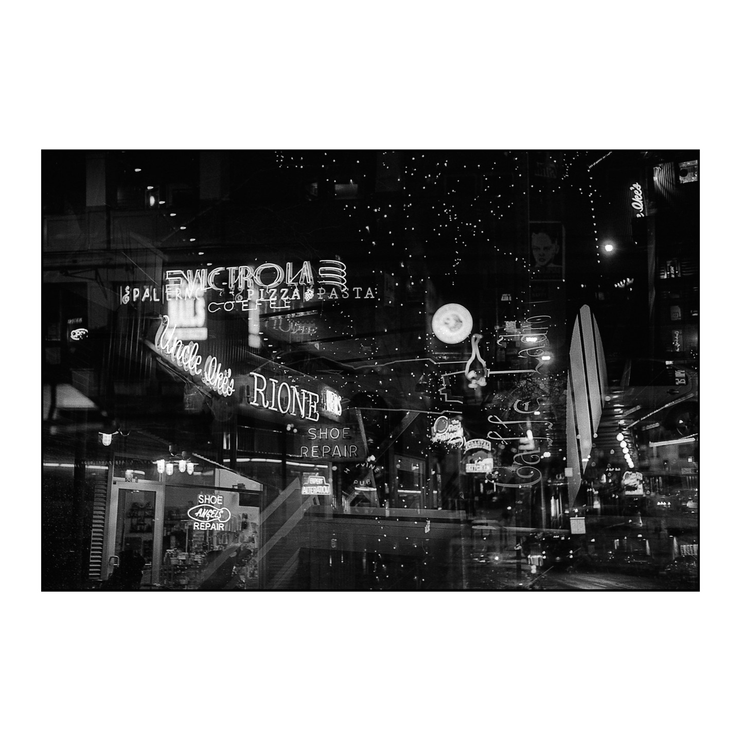 A street at night is filled with neon signs and reflections.
