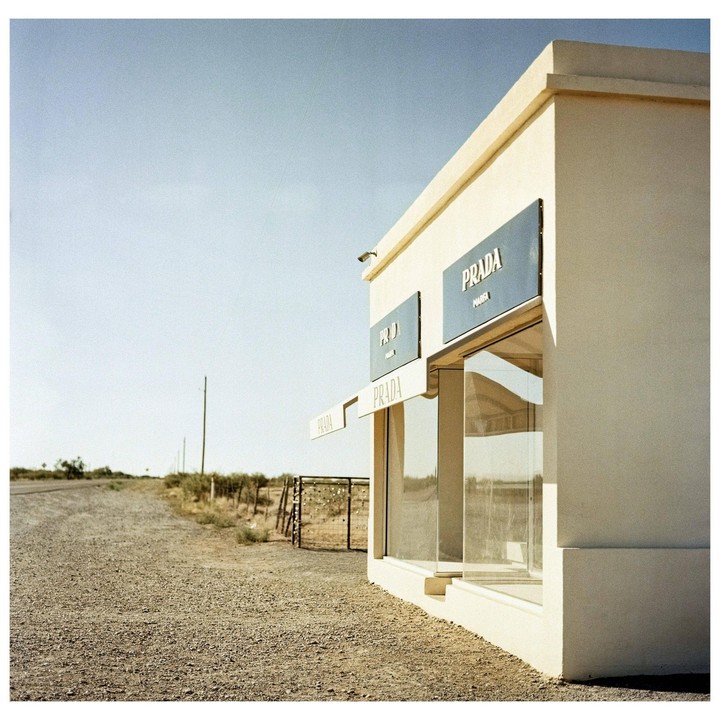 A Prada store stands alone on a gravel road in the desert.