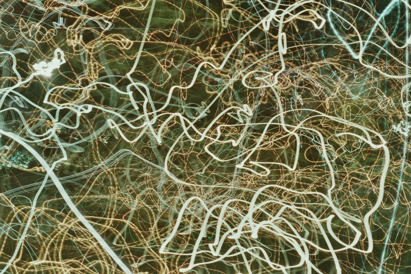 Streaks of light create an abstract pattern against a dark background.