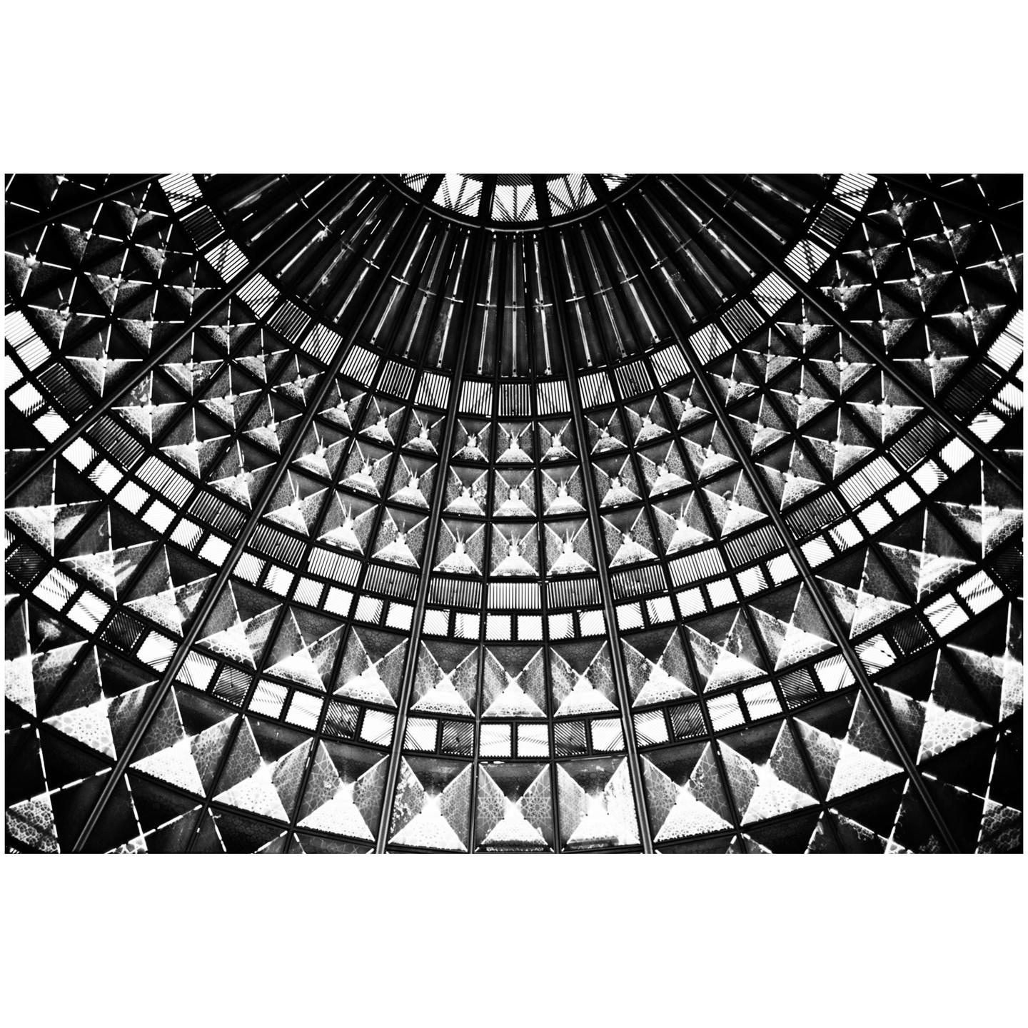 A black and white abstract image shows a geometric pattern of squares and triangles.